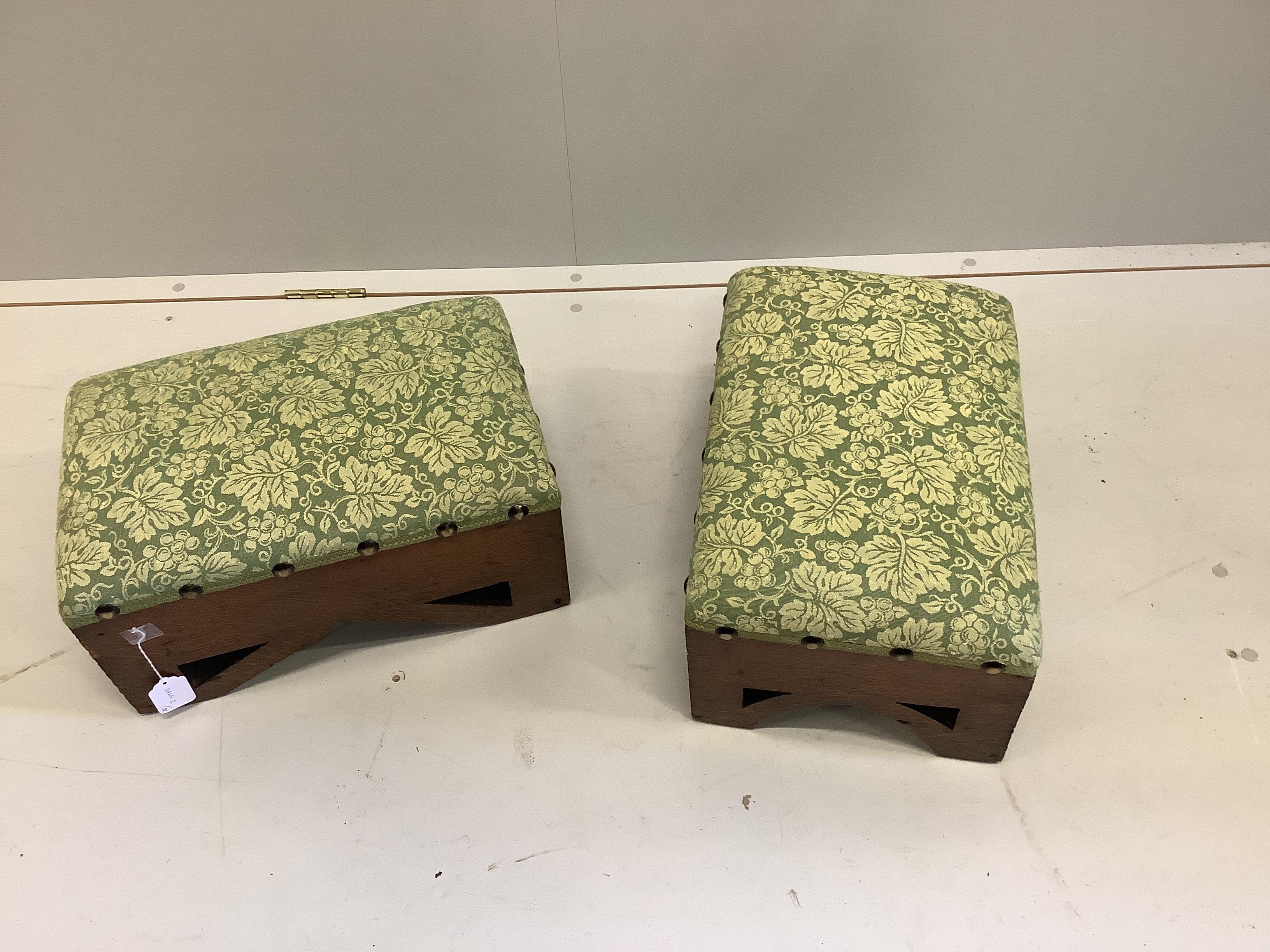 A pair of rectangular Gothic style oak footstools, width 46cm, depth 30cm, height 23cm